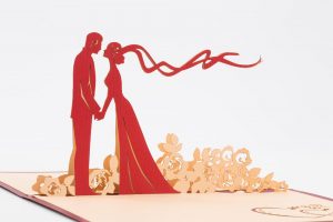 Pop upWedding Card: Bride and groom holding handa about to kiss, standing in flowers wind blowing (inside close-up)