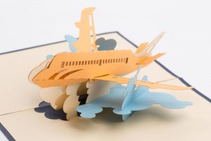 Pop up greeting card: A 3D model of a jet flying through clouds.