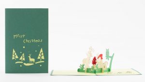 3D pop up greeting cards, a 3D Christmas scene with a reindeer, bear, owl, squirrel, deer sitting around a campfire. Cover and open