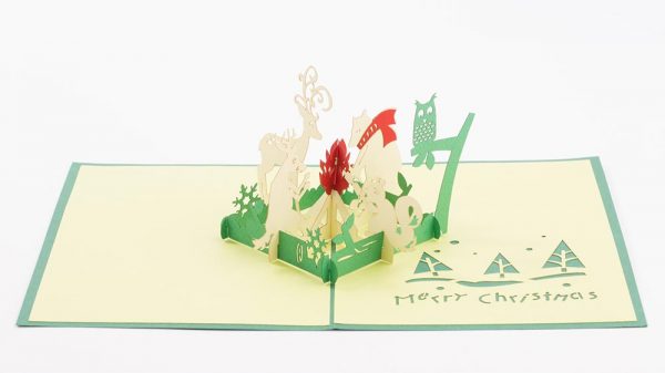 3D pop up greeting cards, a 3D Christmas scene with a reindeer, bear, owl, squirrel, deer sitting around a campfire.
