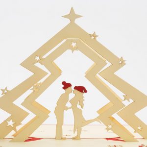Christmas pop up greeting cards: A 3D pop up scene with a couple kissing under a Christmas tree.