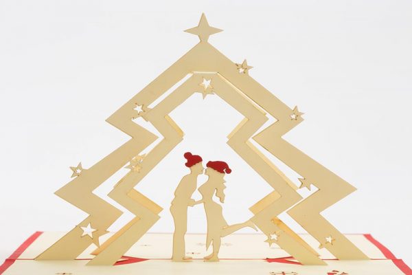 Christmas pop up greeting cards: A 3D pop up scene with a couple kissing under a Christmas tree.