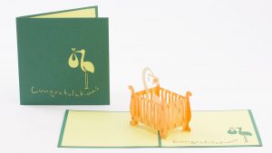 Baby 3D pop up card: A crib with a child inside popped up.