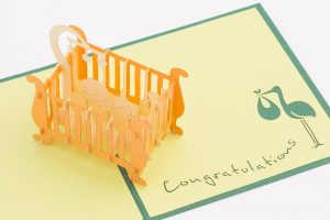 Baby 3D pop up card: A crib with a child inside popped up.