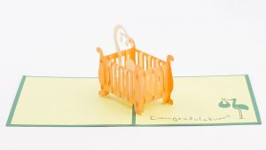 Baby 3D pop up card: A crib with a child inside popped up.
