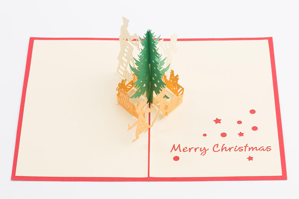 3D pop up greeting cards , Card open showing a 3d scene of parents with children decorating a Christmas tree