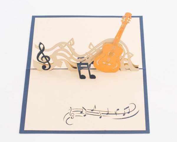 3D pop up greeting cards, card open showing a guitar with music notes. wide view