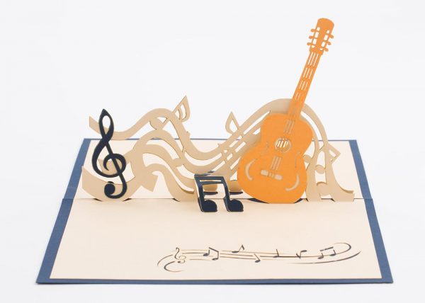 3D pop up greeting cards, card open showing a guitar with music notes.close up