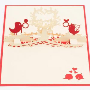 Love Birds holding wedding rings on a heart shaped flower. 3D pop up greeting card.