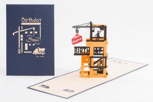 3D pop up greeting card: Happy birthday card open with a 4 story construction site with a crane and workers.