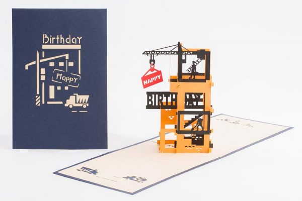 3D pop up greeting card: Happy birthday card open with a 4 story construction site with a crane and workers.