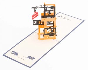 3D pop up greeting card: Happy birthday card open with a 4 story construction site with a crane and workers.