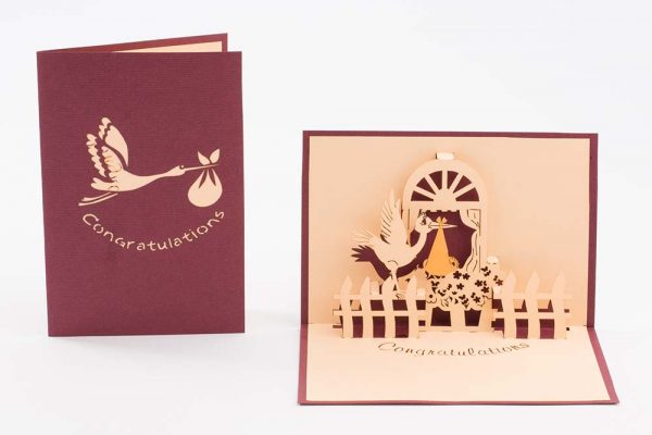 Pop up Baby greeting card. Stork perched on a window ledge with baby