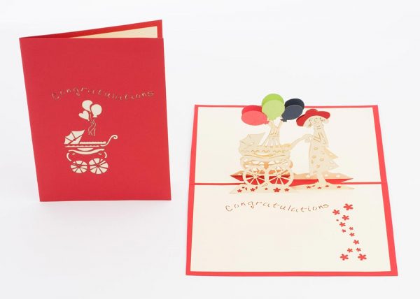 Pop up Baby greeting card: A new mother pushing a baby stroller with a red,green and blue balloons.