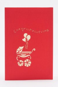 Cover of card, red with congratulations and a baby stroller with balloons