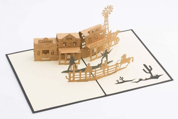 Wild West 3D pop up greeting card: Old west town with a saloon,bank,hotel, a gunfight and horses.(Card open)