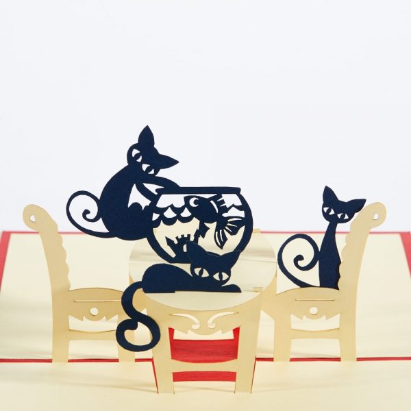 Cats pop up greeting card: Two cats sitting around a table with one cat pawing at the fish bowl.Red.