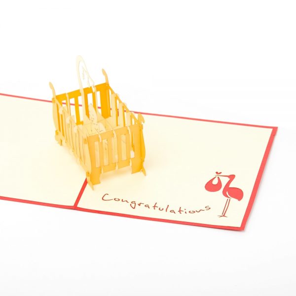 Baby 3D pop up card: A crib with a child inside popped up with red.