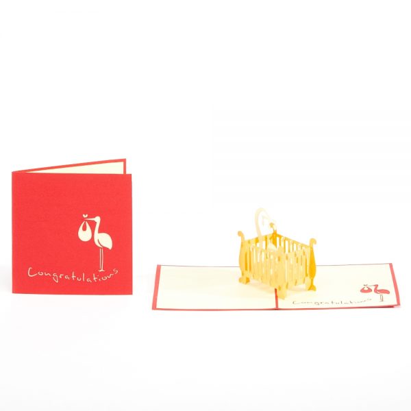 Baby 3D pop up card: A crib with a child inside popped up with red.