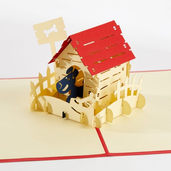 Dog pop up greeting card: A dog house with a little black puppy standing half in the house, with little yard around dog house.