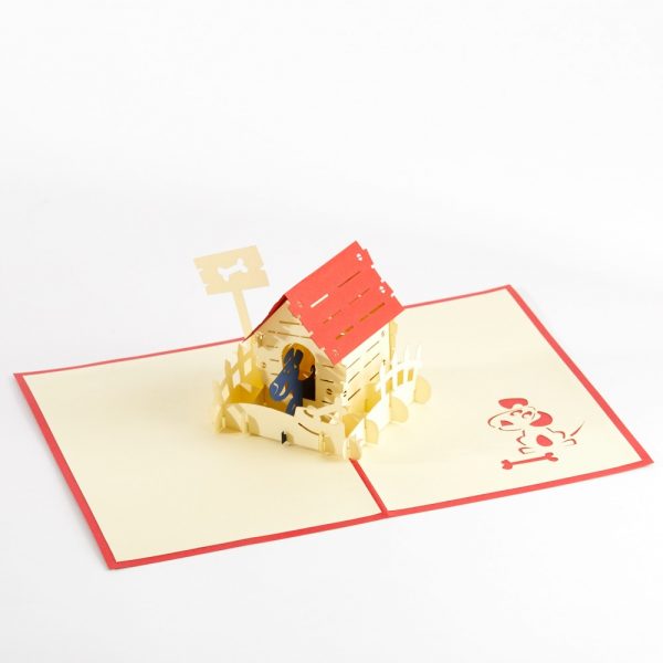 Dog pop up greeting card: A dog house with a little black puppy standing half in the house, with little yard around dog house.