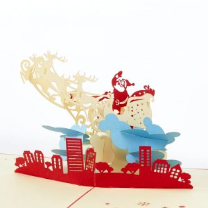 Christmas pop up greeting card: Santa Claus flying his sleigh and reindeer above a city.