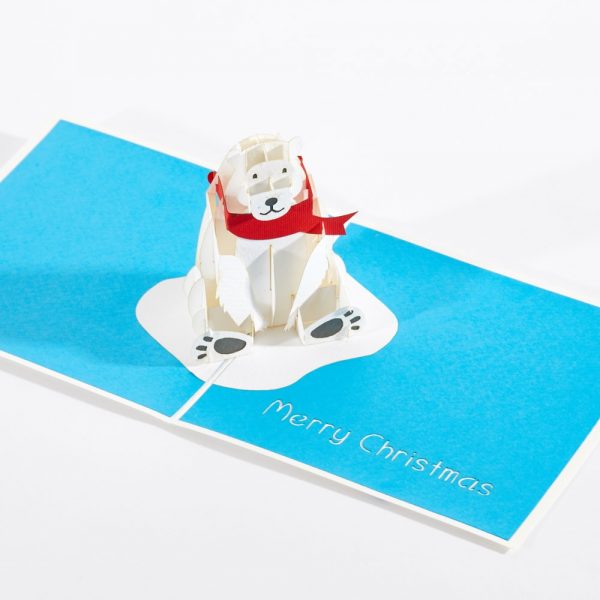 Pop up card. Polar bear wearing a red scarf pops up with Merry Christmas.